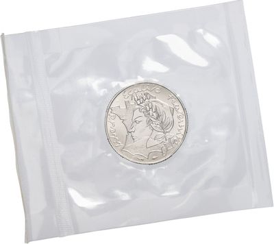 a close up of a coin in a plastic bag on a white background