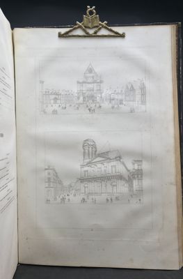 an open book with a drawing of a building on it