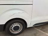 a white van parked in a parking lot next to a building