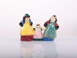 three figurines of a woman, a man and a child