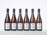 six bottles of wine are lined up on a table