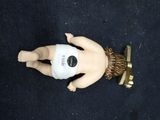 a doll that is laying on the ground with a pacifier on it