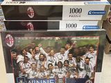 two puzzle boxes with a picture of a soccer team on them