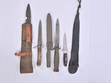five different types of knives displayed on a wall