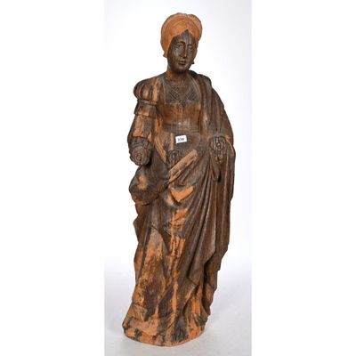 a wooden statue of a woman holding a child