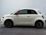 a small white car that is parked in a room