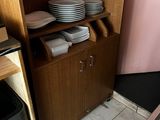 a cabinet with plates and bowls on it in the kitchen