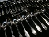 a lot of silver spoons and spoon spoons on a table