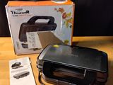 an image of a toaster sitting on top of a wooden table next to a box