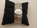 a close up of a black pillow with a silver bracelet on it