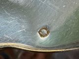 a close up of a metal object with a hole in it