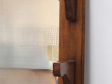 a mirror hanging on the wall in the corner of a room