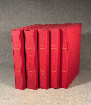 four red books sitting on top of each other on a table