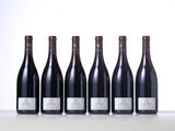 six bottles of wine lined up in a row on a table