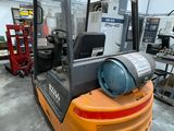 a forklift truck that is parked in a warehouse