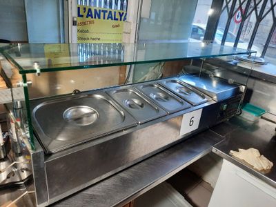 stainless steel counter top with three pans of food on it