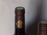 a bottle of wine sitting next to a bottle of wine