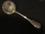 a spoon that is sitting on a black surface
