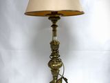 a lamp that is sitting on a table with a lamp shade on it