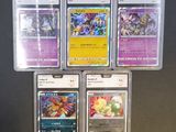four different pokemon cards in plastic cases on a table