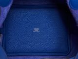 the inside of a blue handbag with a zipper on it