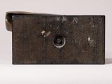 a small metal object that is sitting on a white surface