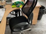 a desk with a chair and a computer on it
