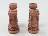two brown candles that are sitting on a white table