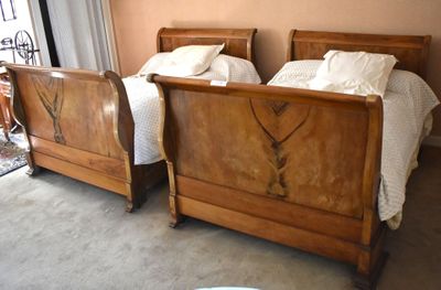 two beds that are made up in a room