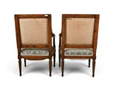 pair of antique chairs with cane backrests and upholstered cushions
