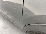 a close up of a car ' s front bumper with a crack in it