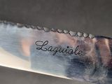 someone is holding a knife with the word legique written on it