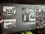 a person holding a book with pictures of buildings in it