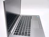 a silver laptop with a black keyboard on a white surface