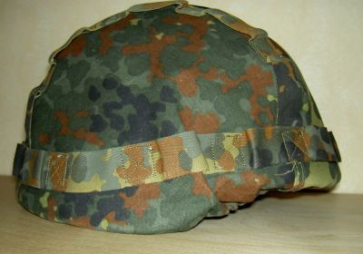 a close up of a camouflage helmet on a table