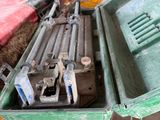 a green box with tools in it sitting on top of a cart