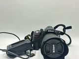 a black camera with a cord attached to it