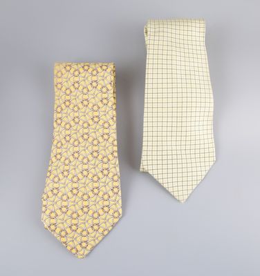 a pair of yellow and white neck ties on a gray background
