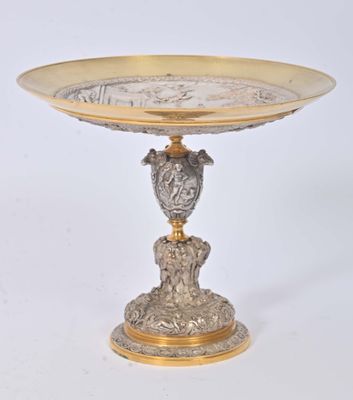 a silver and gold plate with a bird on it