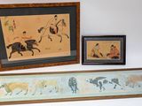 two framed pictures of a man on a horse and a woman on a horse