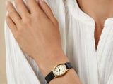 someone is wearing a watch and a white shirt with a black band