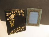 two picture frames sitting next to each other on a table