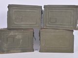four army green boxes stacked on top of each other on a white surface