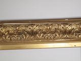 an image of a mirror with a gold frame and a gold flower decoration
