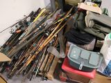 a pile of fishing rods and other fishing equipment on the floor