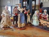many figurines of people standing on a table