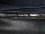the back of a laptop computer sitting on top of a black table