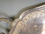a silver tray that has a handle on it