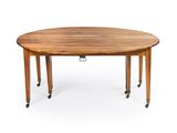 an oval dining table with casteors and a wooden top