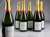 six bouteilles de champagne alignées sur une table